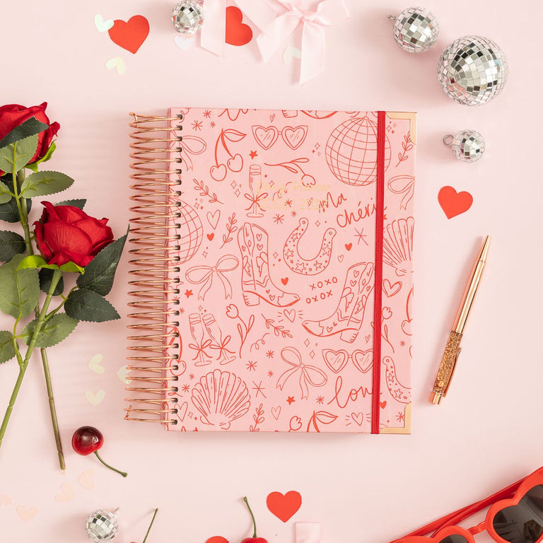 Notebook with decorative elements on a pink background