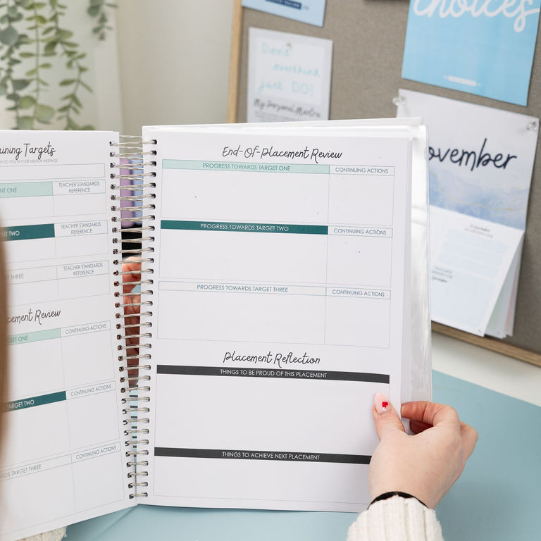 Person holding an open planner with a calendar and notes in the background