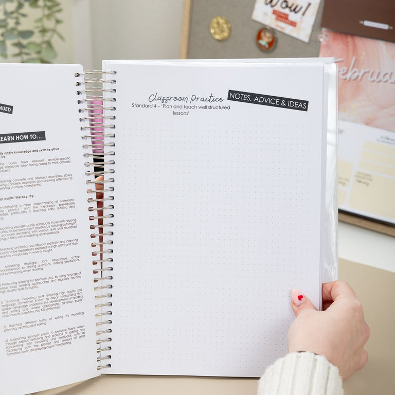 Person holding an open spiral-bound notebook with a blurred background