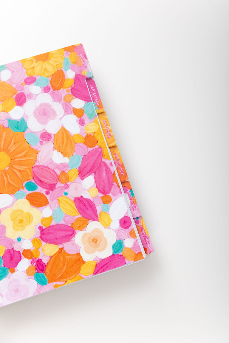 Floral notebook with colorful design on a white background