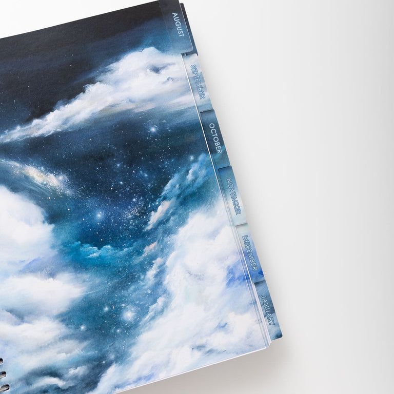Notebook with a cloud and starry sky design on a white background