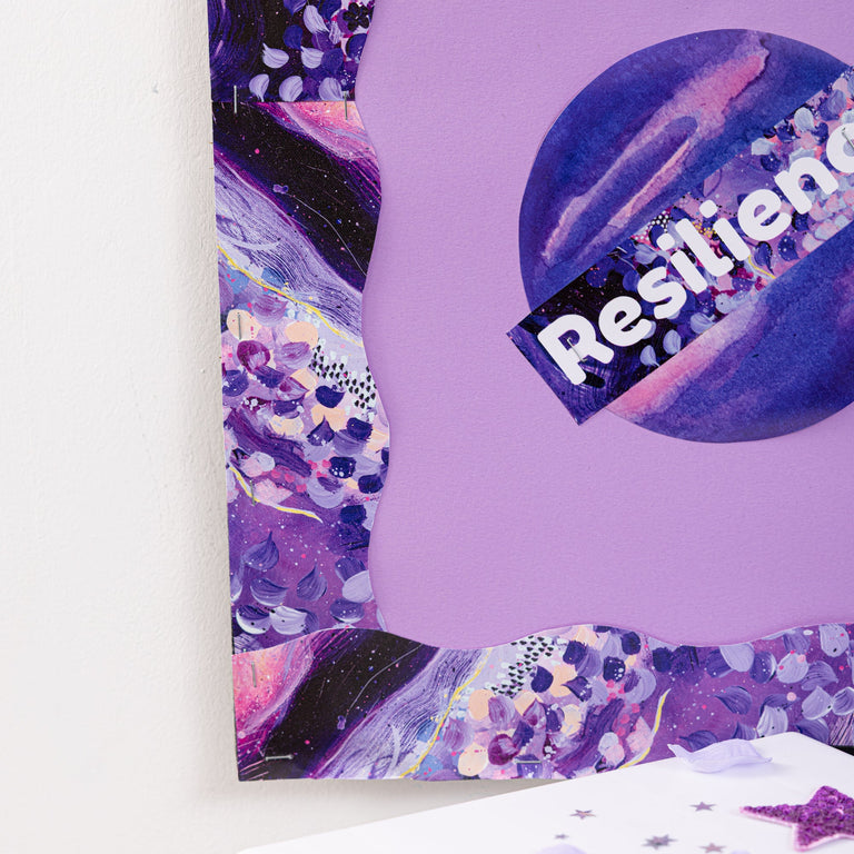 Purple notebook with 'Resilience' sticker and decorative elements on a white background