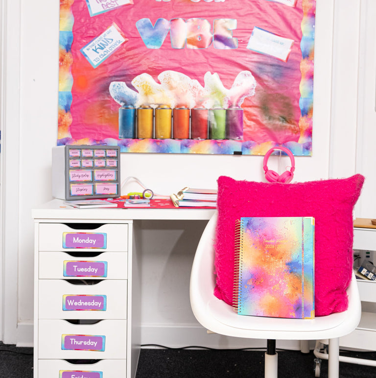 Colorful classroom setup with a desk, chair, and bulletin board.